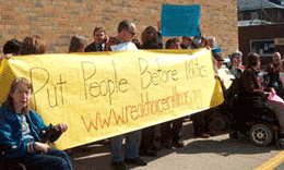 photo of crip activists holding sign 'put people before politics'