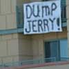 photo of banner hanging out of upstairs window of Omnh Hotel reading 