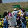 photo of group of protesters getting ready to go up to Omni hotel to protest. Signs read, 